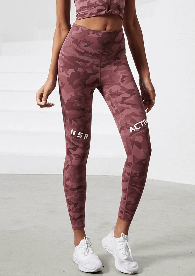 Woman wearing workout camouflage high waist seamless leggings with pockets, perfect for yoga, running, and dancing.